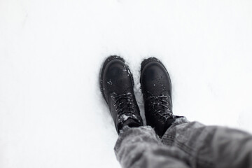 Female feet in boots in the snow