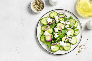 Feta red onion cucumber salad. Space for text, top view.