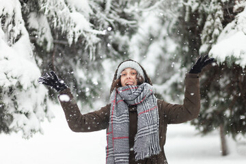 Young cheerful woman glad to snow