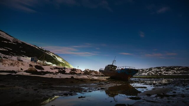 Abandoned ship in Arctica inder Moon and stars winter