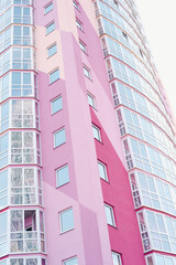 windows on colorful building, pink high-rise building, colored house, residential area 