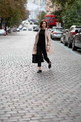 Stylish woman crossing city street