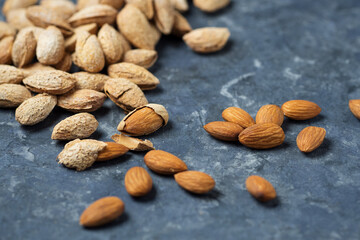 Roasted salted almonds on a dark table
