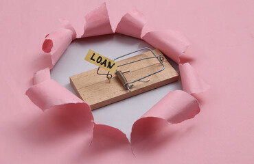 Mousetrap through the torn hole pink paper.