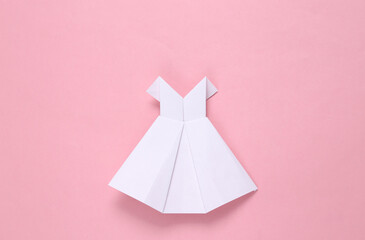 White origami wedding dress on pink background