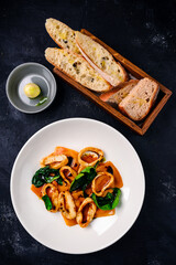 Stewed squid rings in sauce for Healthy mediterranean dinner.