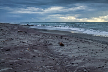Stormy weather approaching a desolate beach in New Zealand