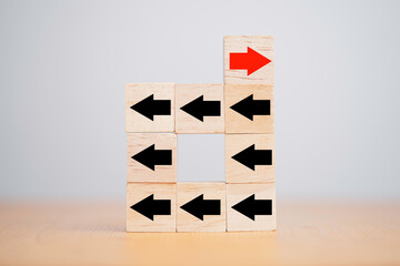 One of red arrow move to opposite direction with others black arrow which print screen on wooden...