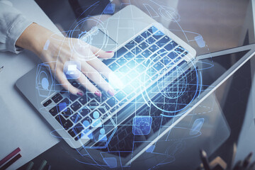 Double exposure of woman hands typing on computer and social network theme hologram drawing. People media concept.