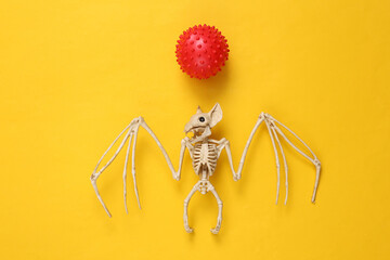 Bat skeleton and virus strain model on yellow background