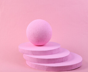 Fototapeta na wymiar Pink podium with ball on pink floor. Platforms for product presentation, mock up background. Abstract composition in minimal design, pastel colors trend. Geometric shapes.