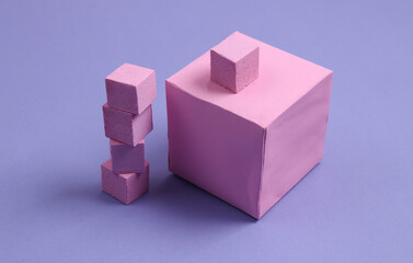 Pink cubes on a pastel purple background. Geometric shapes. Minimalism