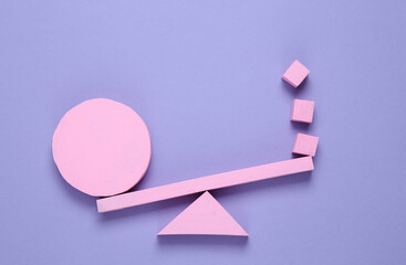 Balancing swing with cube and circle on pink background. Minimalism. Geometry shapes. Creative...