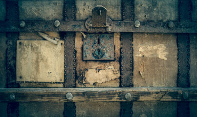 front of an old shabby chest with a padlock and a blank sticker - 427243038