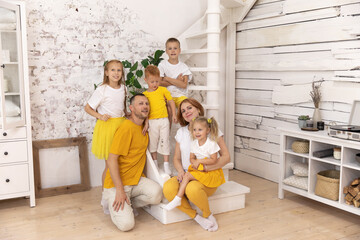 Family sitting on staircase smiling.