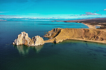 Lake Baikal in autumn. Cape Burkhan, Shamanka rock on the Olkhon island. Aerial view.