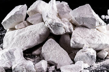 Calcium and Magnesium stones, black background. Called virgin lime or quicklime - obrazy, fototapety, plakaty