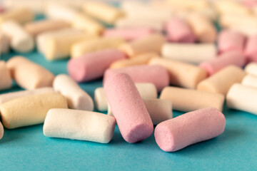 Fototapeta na wymiar Colorful marshmallows on a blue background. Close-up. Selective focus.