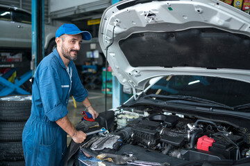 Auto services and Small business concepts. Auto mechanic hands using wrench to repair a car engine.