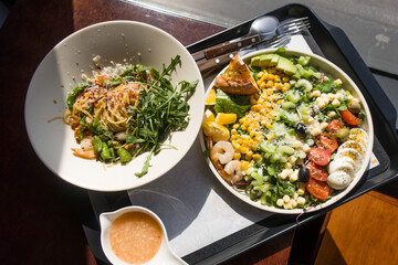 Classic cobb salad with shrimp, tomatoes, eggs, avocado and cheese.