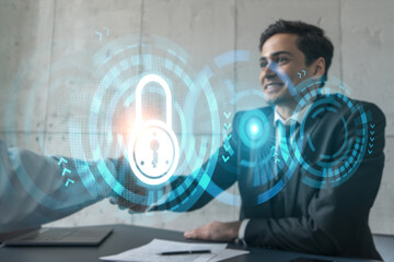 Two businessman shaking hands and lock icon hologram. Double exposure. Concept of protection business data. Handshake.