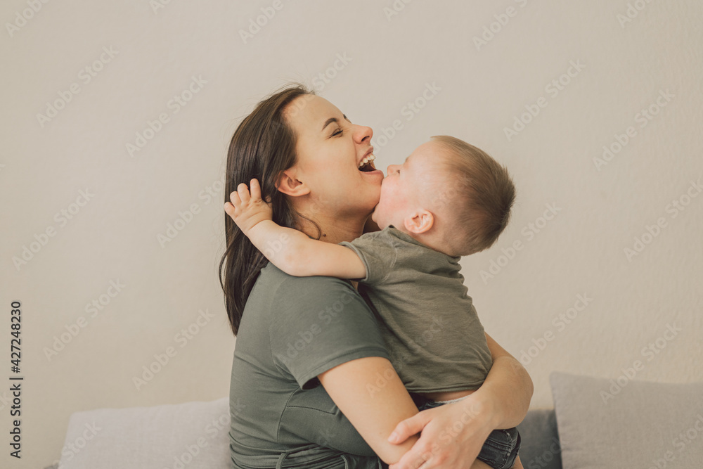 Poster Happy loving family. Mom and his son are hug at home. Mother's day.