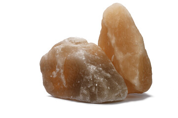 two large pieces of natural salt on a white isolated background