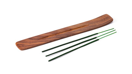 incense sticks lying next to a wooden stand for them on a white isolated background