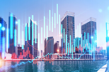 Fototapeta premium Skyscrapers of Dubai business downtown. International hub of trading and financial services of Western Asia. FOREX graph and chart concept. Double exposure. Dubai Canal waterfront.