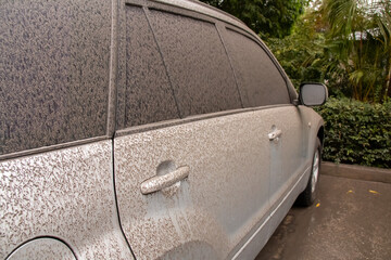St. James, Barbados - April 11 2021: A grey SUV vehicle coated in volcanic ash from St. Vincent and...