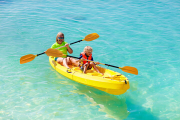 Kids kayaking in ocean. Family in kayak in tropical sea