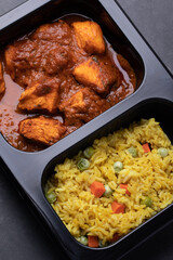Chicken Tikka Masala and Turmeric Rice Indian cuisine in black box