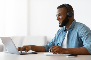 Online Education. Happy Black Guy Study In Internet, Watching Webinar On Laptop