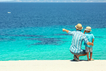 father with a child by the sea