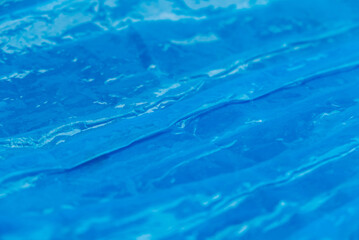 Blue crumpled plastic wrap as a background texture. Copy, empty space for text