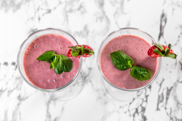 Strawberry banana smoothie. Strawberry dessert. Light gray background. Place for you text.