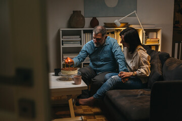 romantic middle aged couple celebrating their anniversary at home