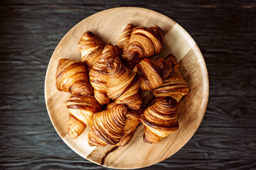 Fresh baked croissants. Warm fragrant butter croissants and rolls on a wooden stand. French and...