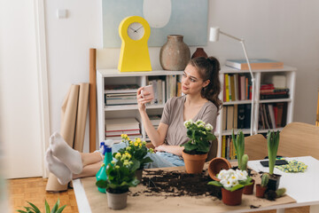 woman gardening houseplants at her apartment.