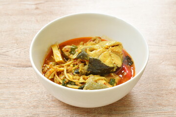 spicy boiled bamboo shoot with slice catfish in coconut milk and curry on bowl