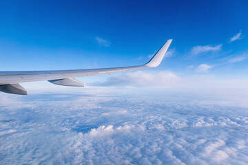 Fototapeta na wymiar Airplane wing on a background of blue sky flight time.