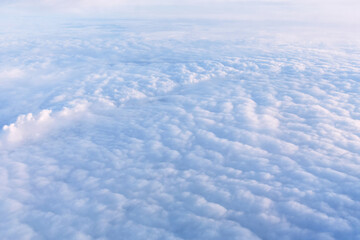 Fototapeta premium Cloudscape in sunny weather - white dense clouds floating over land surface, birds eye view