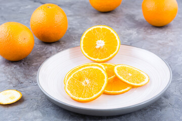 Pieces of fresh orange on a plate on the table. Vitamins, diet and vigor