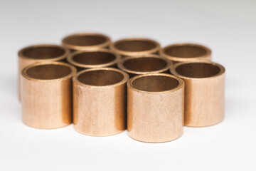 Group of sleeve bronze bearings on white