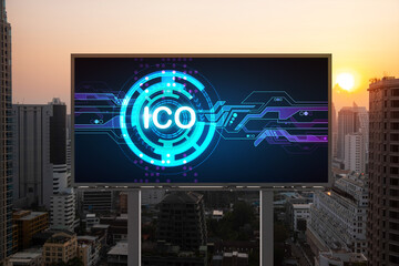 ICO hologram icon on billboard over panorama city view of Bangkok at sunset. The hub of blockchain...