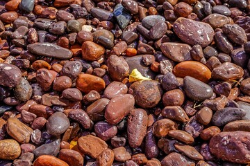 Closeup of colorful beach stones in the waves along the North Shore of Lake Superior in Minnesota