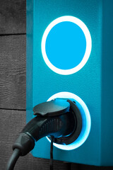 blue electric charging station for a modern electric eco car. Hybrid car electric charger station , vertical image