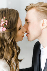 a blonde man kisses a Caucasian blonde girl. wedding photo shoot