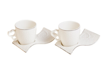 Two white porcelain tea, coffee cups with saucer. Isolated on white