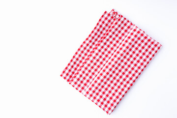 Isolated background red and white fabric checkered tablecloths neatly folded on white background with copy space.